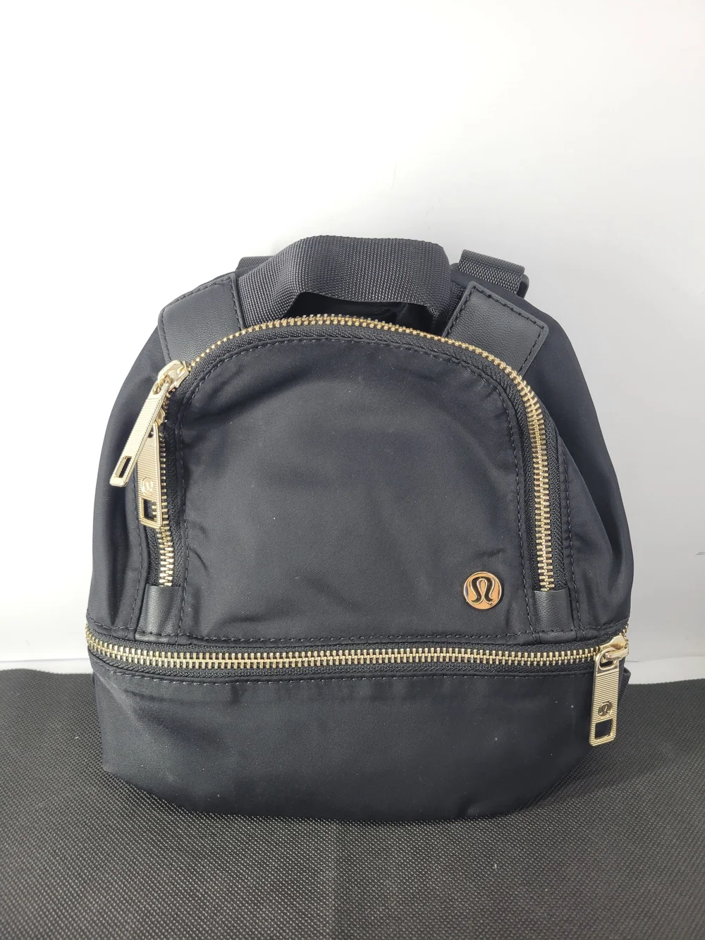 lululemon athletica Black Mini Backpack with Gold Hardware Accent